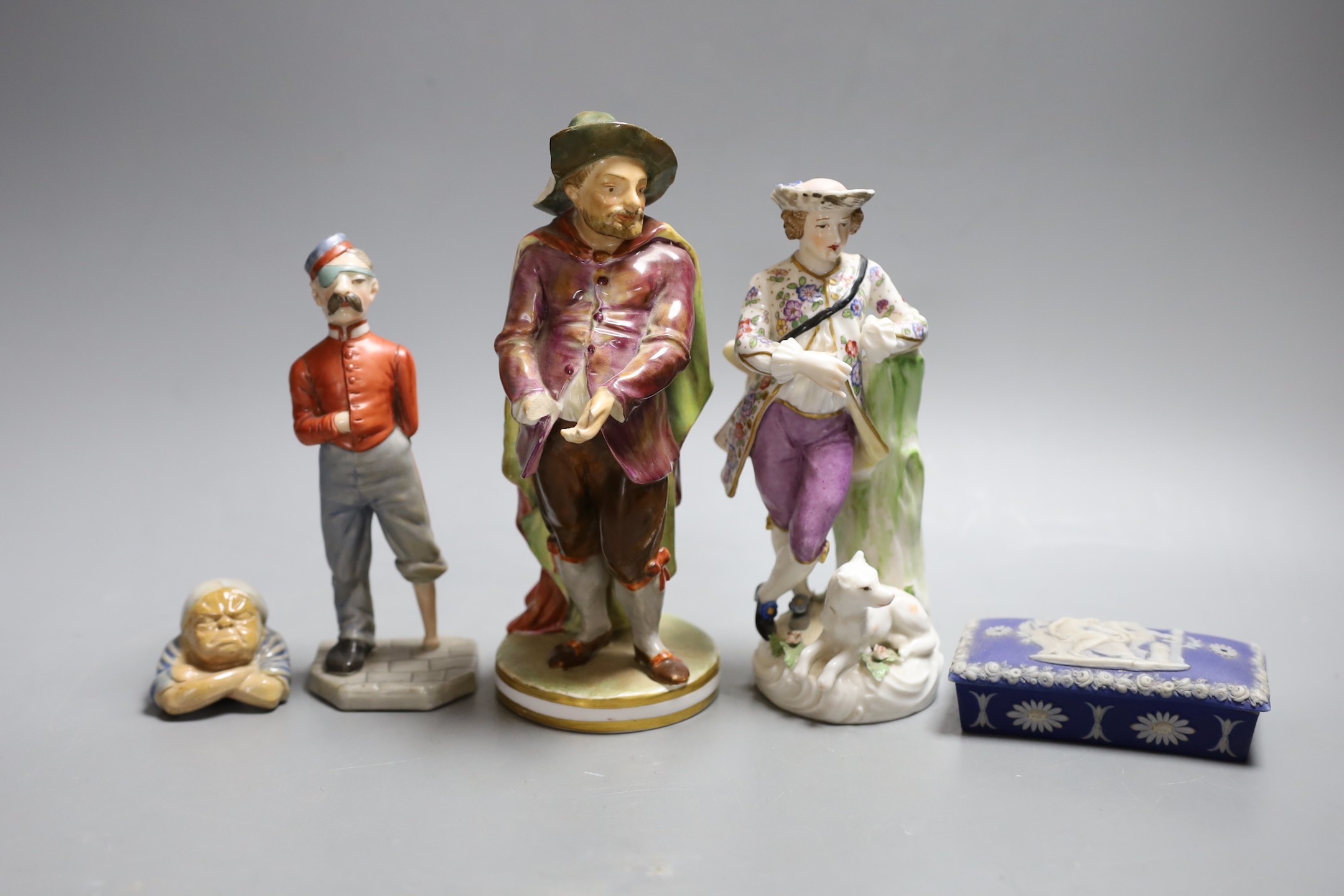 A Crown Derby figure, 19.5cm, a Royal Worcester figure of an amputee, a continental porcelain group, the cover from a Doulton votes for women inkwell and a box and cover